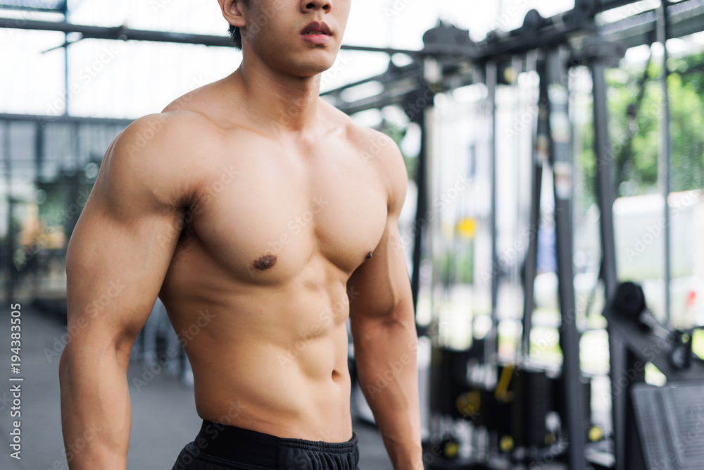 strong fitness man posing muscular body and doing exercises for bodybuilder in the gym, fitness concept, sport concept strong fitness man posing muscular body and doing exercises for bodybuilder in the gym, fitness concept, sport concept