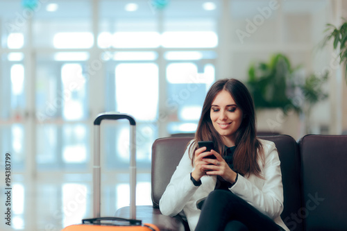 Woman Reading Phone Messages in Airport Waiting Room