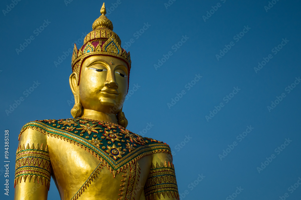 Fototapeta premium Golden image of buddha thai style on blue sky background