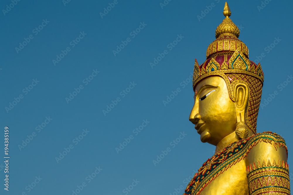 Fototapeta premium Golden image of buddha thai style on blue sky background