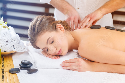 Beautiful, young and healthy woman in spa salon. Massage treatment