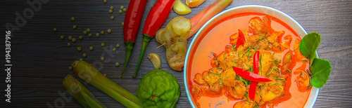 red curry chicken, Thai Spicy food and fresh herb ingredients on wooden top view / still life, selective focus