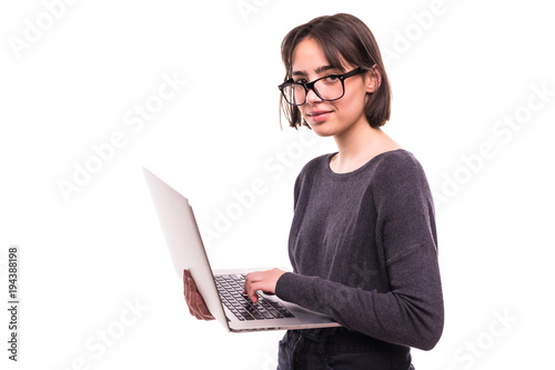 Portrait of a smiling teen girl holding laptop computer isolated on a white background