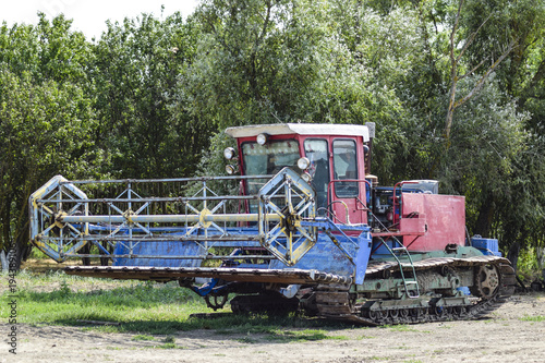 Combine harvesters Agricultural machinery. The machine for harvesting grain crops. Rice header combine harvester.