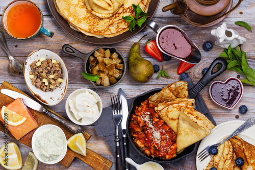 Colorful, tasty and savory breakfast with crepes and different fillings and sauces