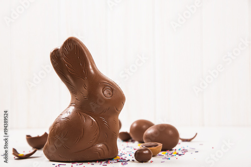 Easter chocolate bunny and eggs on white wooden background