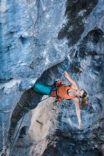 Fototapeta Naklejka Na Ścianę i Meble -  Blonde girl climbs tufa rock, Chitdibi, Turkey