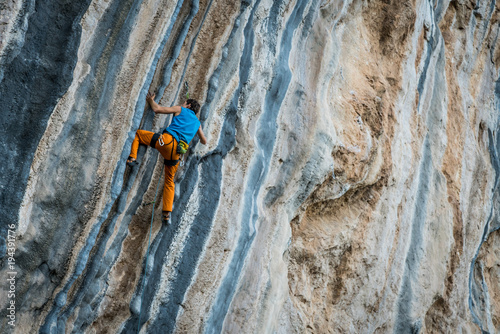 man climbs tufa rock, Chitdibi, Turkey