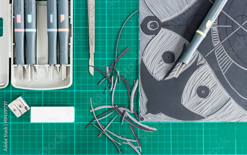 Lino cutting tools on a desktop.