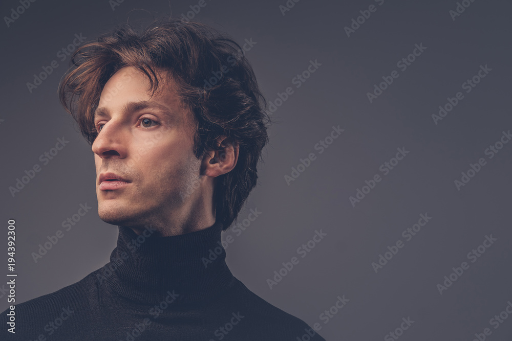 Close-up portrait of a charismatic sensual male in a black sweat Close-up portrait of a charismatic sensual male in a black sweat