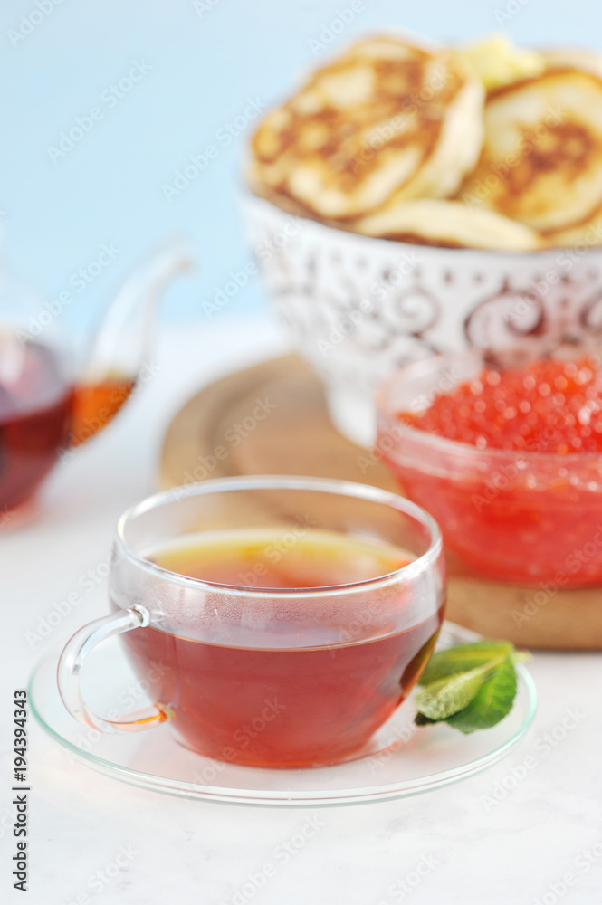 transparent glass mug with black tea and mint transparent glass mug with black tea and mint