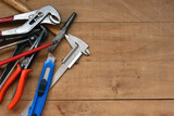 Construction tools on a rustic wood background