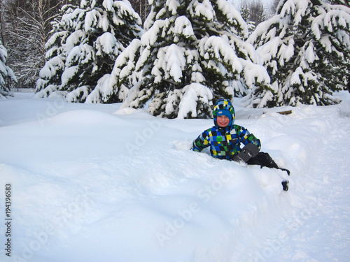 Kid in winter forest