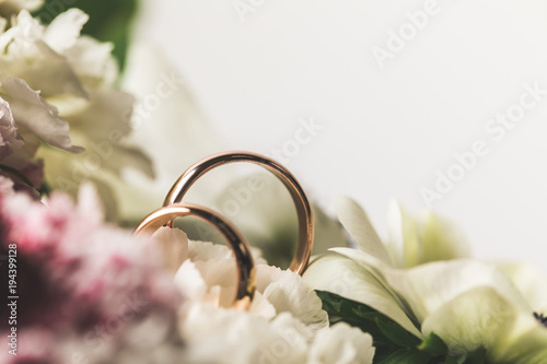 Fototapeta close up view of wedding rings in bridal bouquet