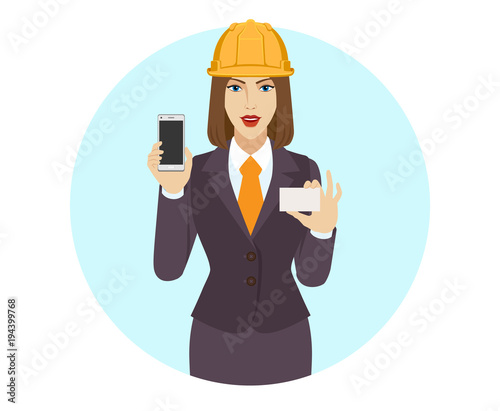 Businesswoman in construction helmet holding a mobile phone and business card