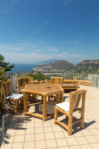 Fototapeta Naklejka Na Ścianę i Meble -  Chairs and table on the terrace overlooking the Bay of Naples and  Vesuvius. Sorrento. Italy
