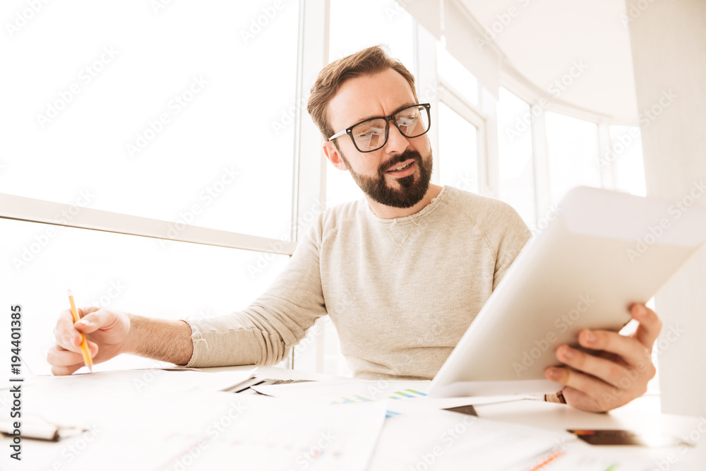 Portrait of a busy man working with documents