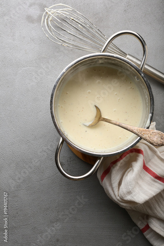 Tableau sur toile Bechamel sauce in saucepan