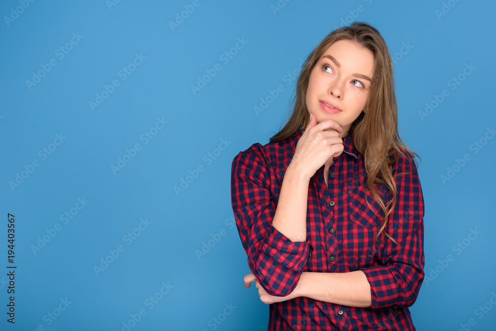 beautiful young thoughtful girl, isolated on blue beautiful young thoughtful girl, isolated on blue