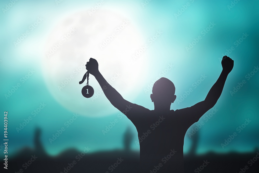 Champion motivator concept: Winner hand raised and holding gold medal  reward against full moon on blue night sky background Stock Photo | Adobe  Stock