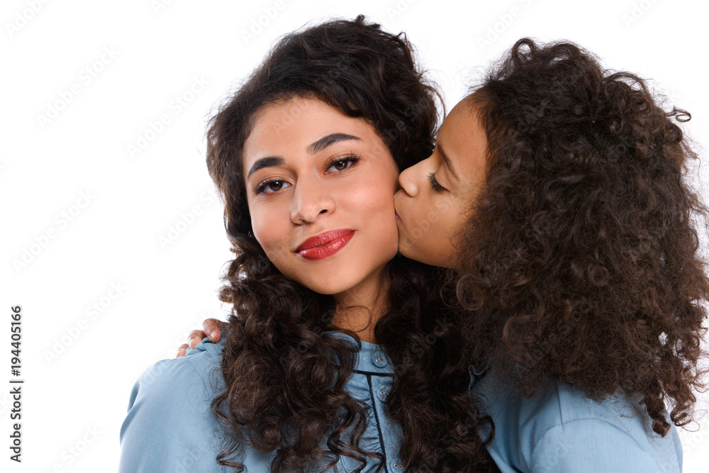 close-up shot of daughter kissing her mother isolated on white close-up shot of daughter kissing her mother isolated on white