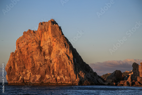 Sunrise Red rock and sea landscape, cape, sea cliffs 