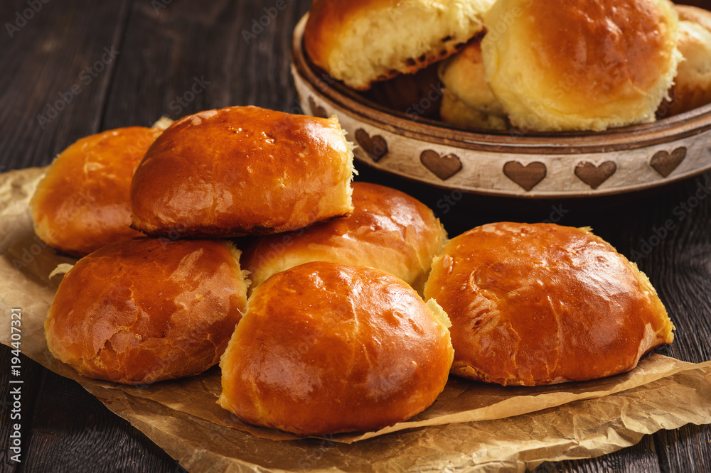 Homemade sweet bread rolls on dark background.