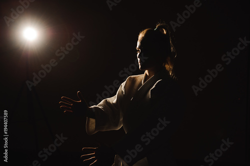 Young girl dressed in hakama practicing Aikido