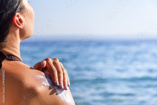 Sunscreen on a woman's shoulder.