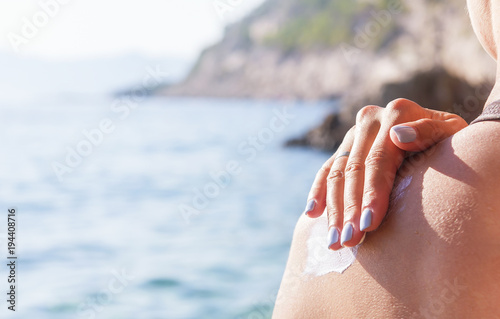 Sunscreen on a woman's shoulder.