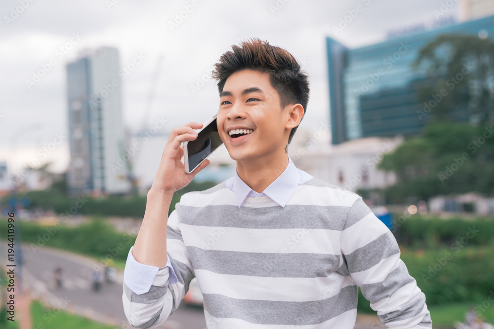 Portrait of handsome young man in city talking on smartphone Portrait of handsome young man in city talking on smartphone