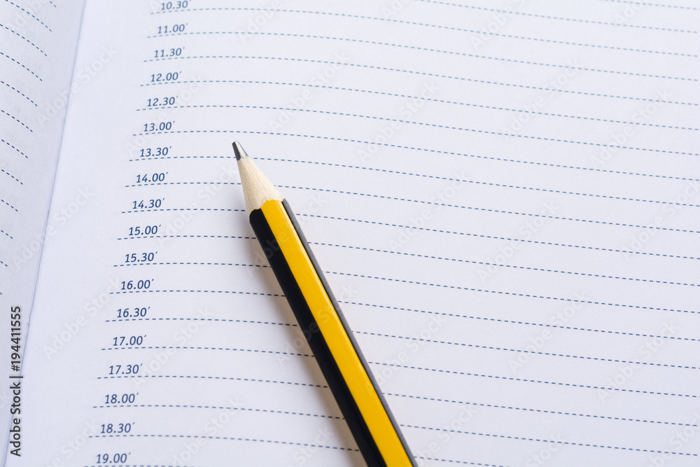 Pencil on a daily planner Pencil on a daily planner
