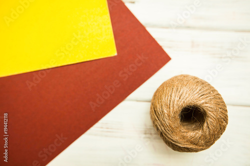 Repair carpenter tools: abrasive papper and rope on white old wooden background, top view, copy space