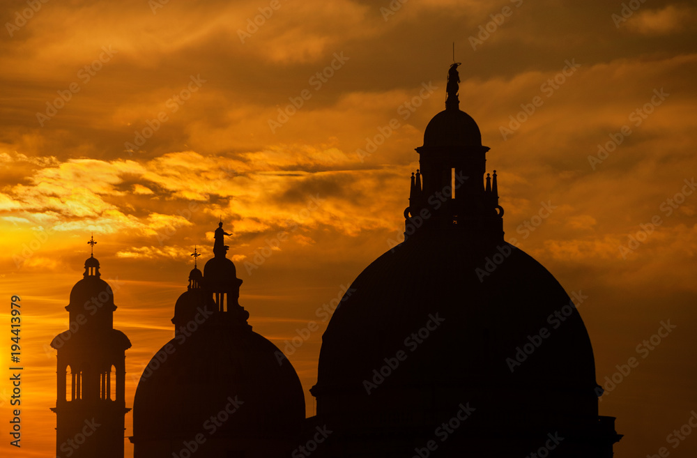 Salute Basilica (Saint Mary of Helath) old domes at sunset in Venice