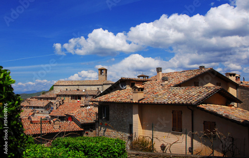 View of the medieval historic center of Montone, a small town in the Umbria countryside in Italy, with old Saint Francis Church and clouds