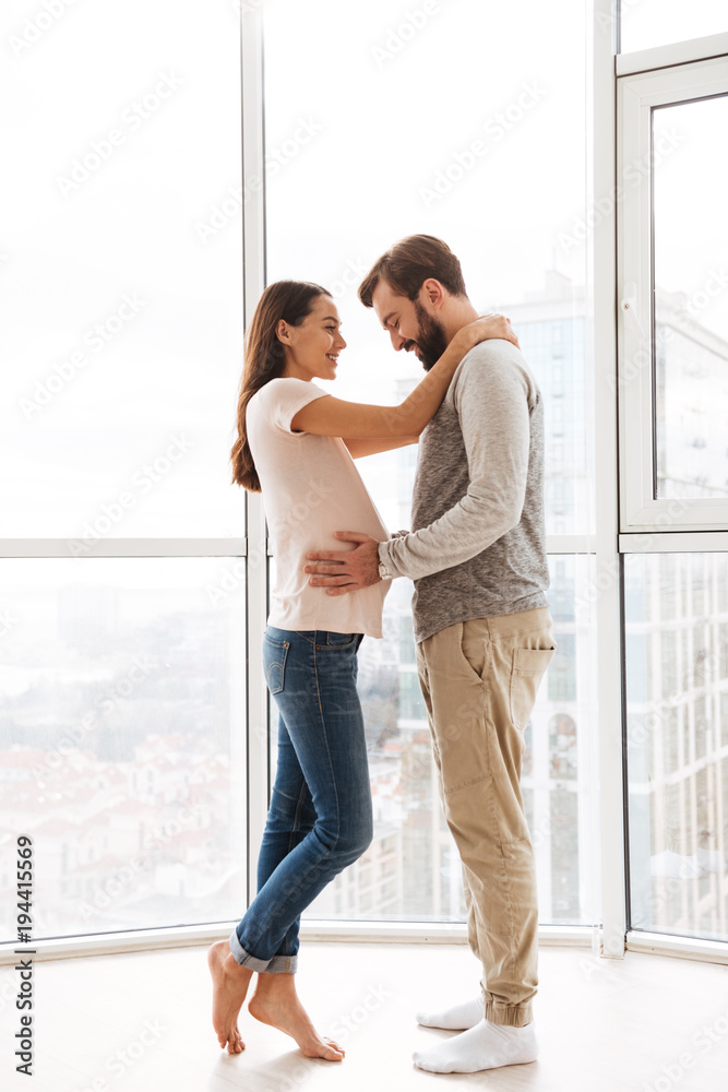 © Drobot Dean - Pretty pregnant young couple hugging © Drobot Dean - Pretty pregnant young couple hugging