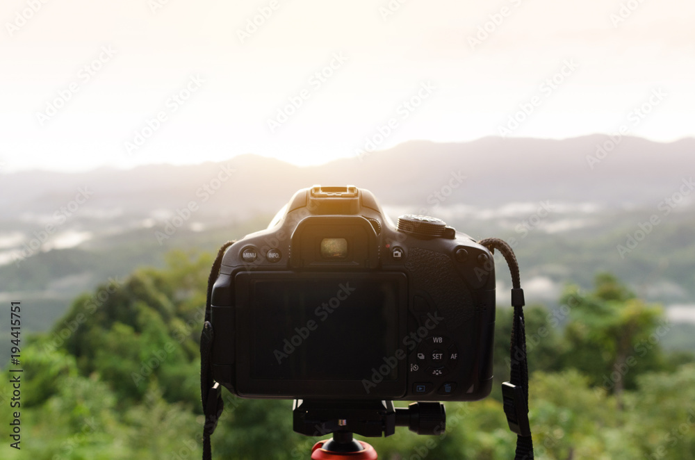 DSLR Camera set on camera tripod for take a landscape photo in selective focus. DSLR Camera set on camera tripod for take a landscape photo in selective focus.