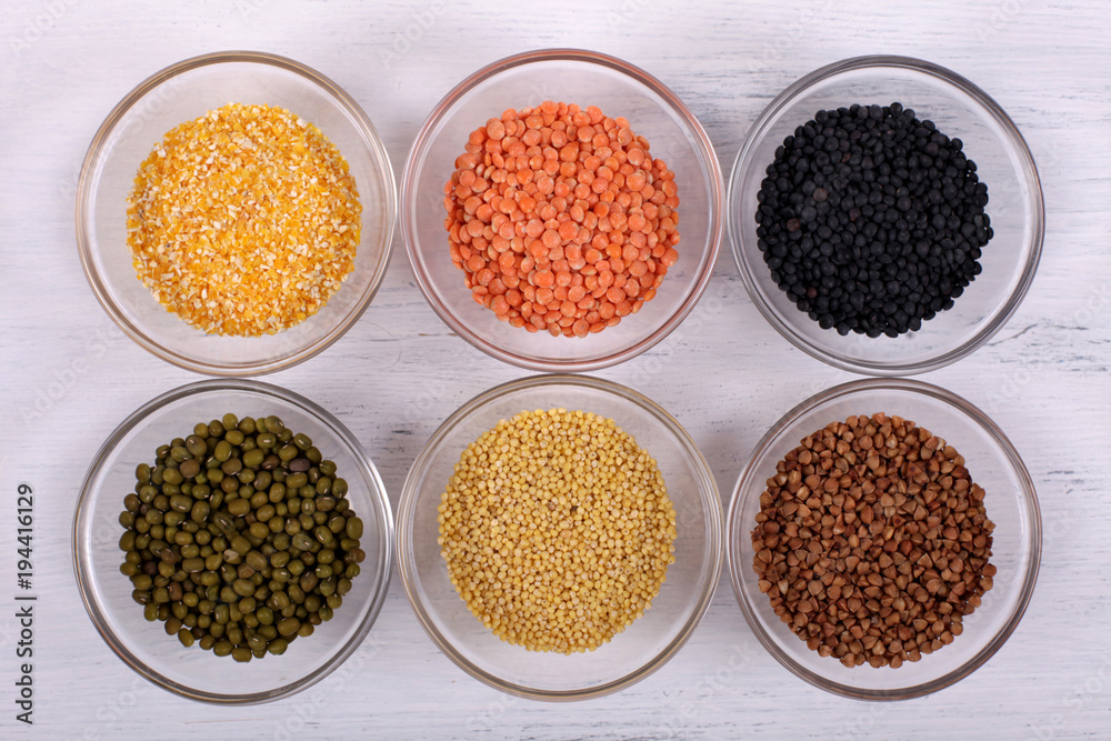 Healthy organic cereals on white wooden background.