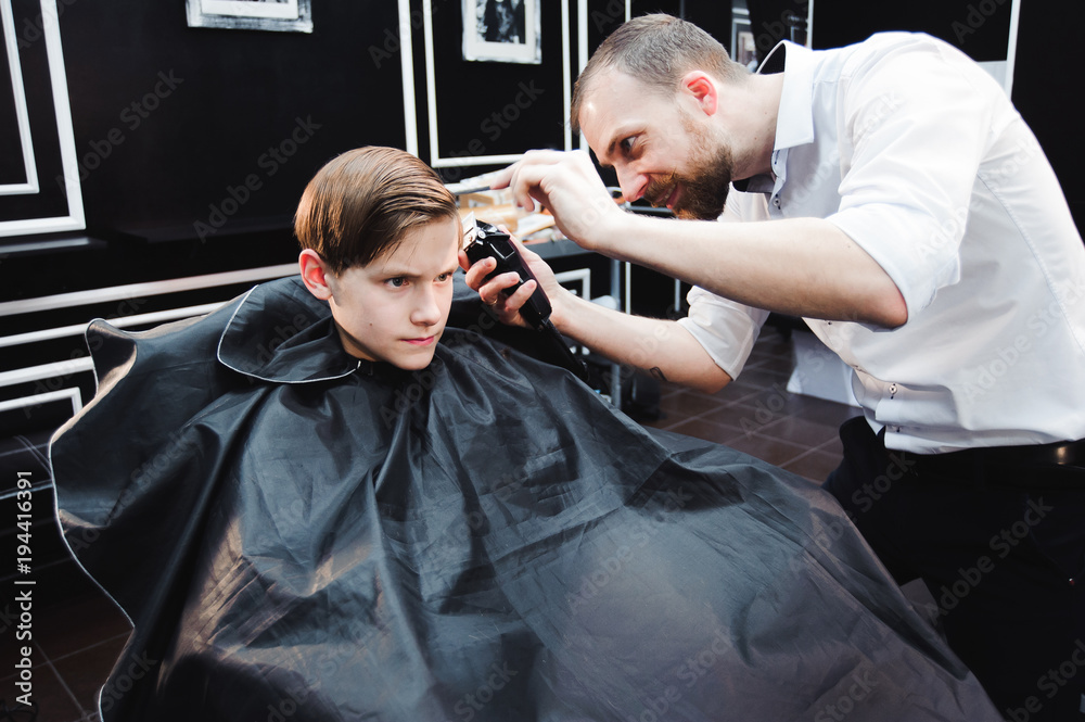 cute young boy getting a haircut