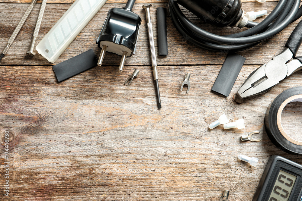 Different electrical tools on wooden background Different electrical tools on wooden background