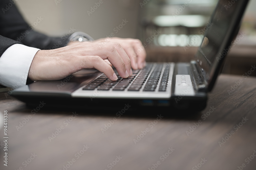 Young Asian businessman working with a laptop in a coffee shop. Young Asian businessman working with a laptop in a coffee shop.