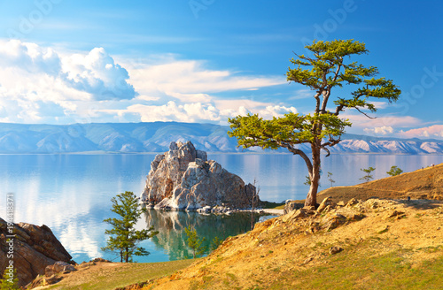 Baikal Lake. Olkhon Island. Beautiful old larch and Shamanka Rock on June afternoon photo