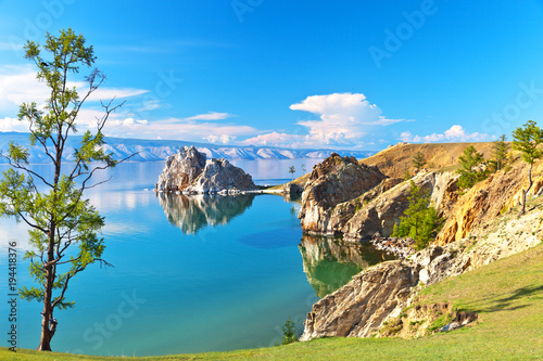 Baikal Lake. Rocky coast of Olkhon Island and Shamanka Rock - a natural landmark on a sunny June afternoon