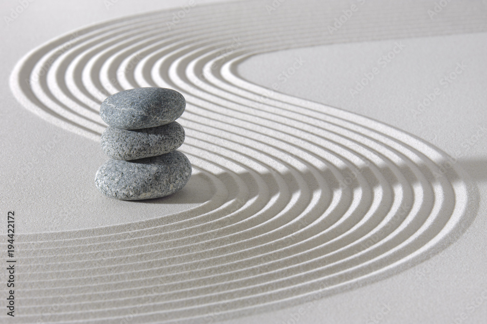 Japanese ZEN garden with stacked rocks in white textured sand Stock