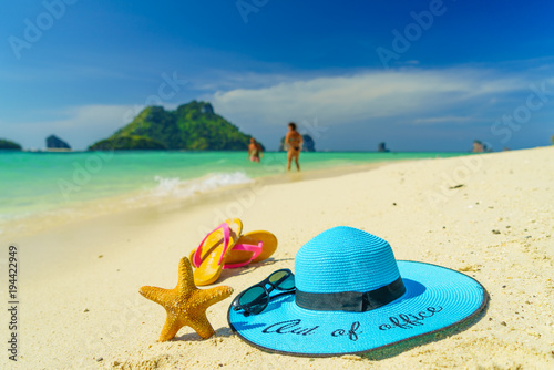 Out of the office Straw hat starfish and sandals onPoda island beach white sand and turquoise sea