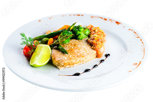 Breaded steak from marble beef (schnitzel) with vegetables in a white plate isolated on white background