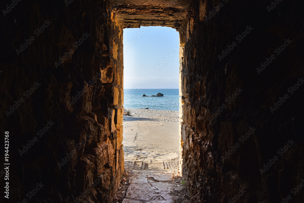 Sea view through ancient tunnel