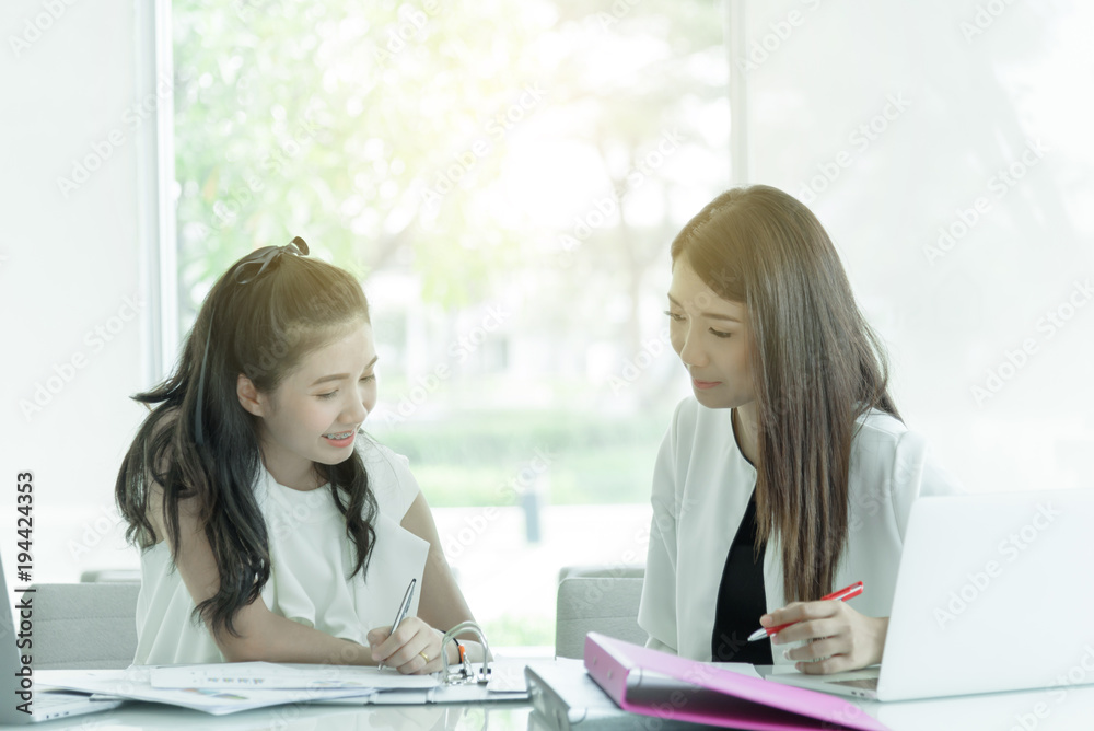 Women working together with happy and smiling in the office interior. Women working together with happy and smiling in the office interior.