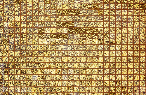 Bright shiny golden square tile background.