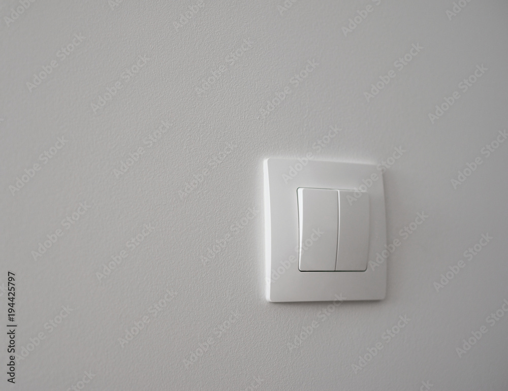 White light switch on a white wall
White light switch on a white wall